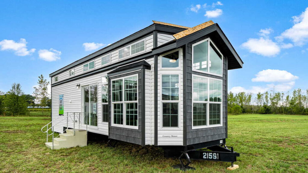 Timber Creek Tiny House Pairs Floor-to-Ceiling Bay Window With Sunken Bedroom Timber Creek tiny house on wheels in USA