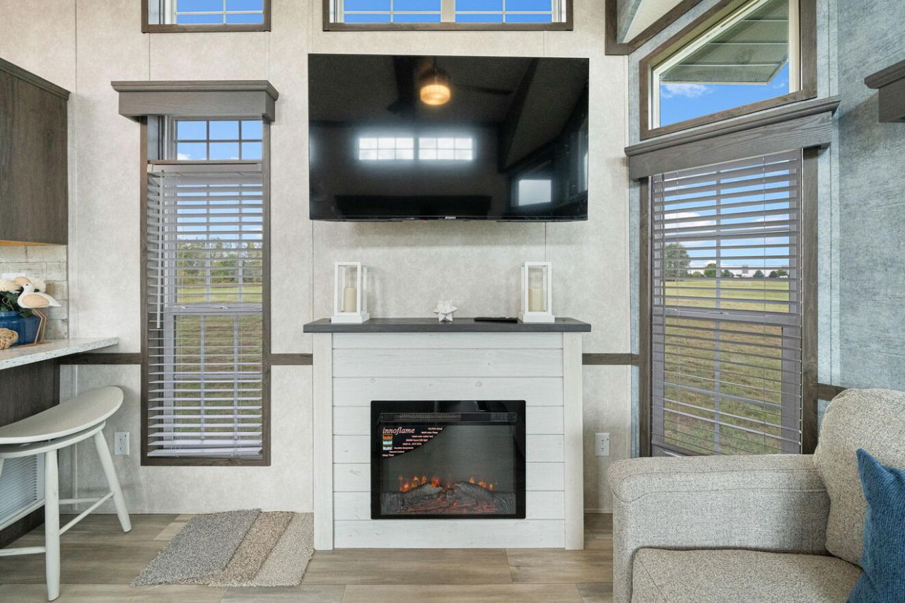 Timber Creek tiny house on wheels fireplace and TV