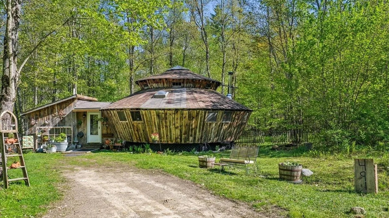 UFO-shaped dreamy rustic cabin-exterior and lush lawn
