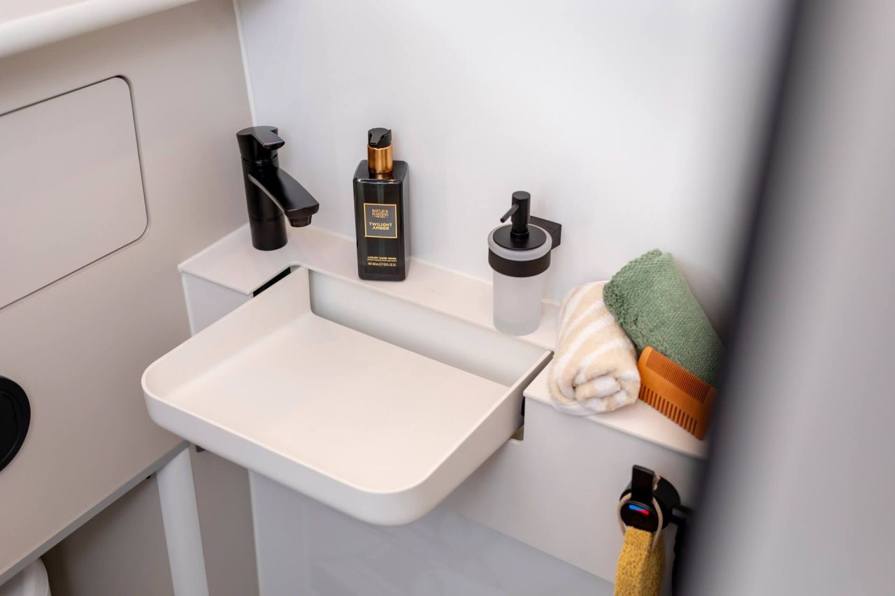 Westfalia Columbus Liner Luxury Camper Van Features Rooftop Terrace Accessed from Bedroom - foldable vanity in bathroom