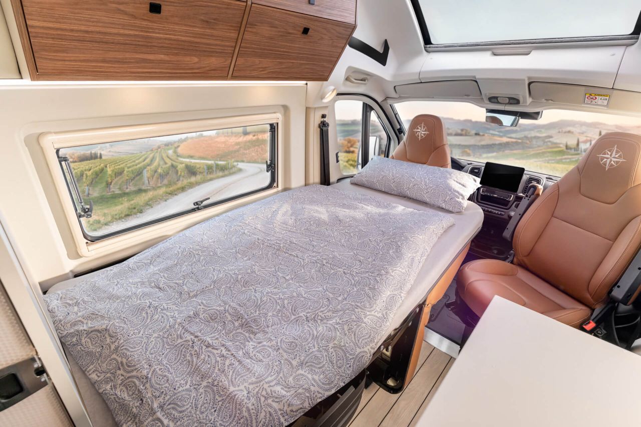 Westfalia Columbus Liner Luxury Camper Van Features Rooftop Terrace Accessed from Bedroom - dining area into bed